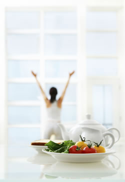 plate of salad with woman in background