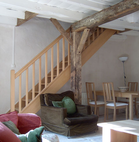 Picture of the lounge and dining area, with staircase to first floor.